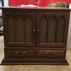 an old wooden cabinet with two drawers