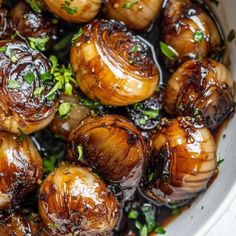 cooked onions with herbs in a white bowl