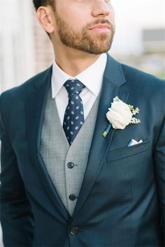 a man in a suit and tie with the words groom style suits vs tuxedos