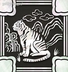 a white tiger sitting on top of a black and white striped wallpaper with clouds in the background