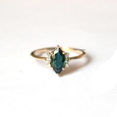 Pretty and simple Teal Sapphire diamond engagement ring. The stones can also be of other shape or kind.Gorgeous Marquise Teal Sapphire Diamond Ring, Stackable Beautiful Ring, Delicate Gemstone Ring, Wedding/Engagement Beautiful Jewelry.Product info:Main gemstone: Teal SapphireShape: Marquise Measurements: approx. 10*5 mmSide stones: white diamondsShape: roundMeasurements: approx. 1.5 mmQuality: I-J color, SI clarity, conflict-freeItem will be resized and shipped within 10 days.ITEM Will BE SHIPP Blue Marquise Engagement Ring, Marquise Gemstone Ring, Green Marquise Diamond Ring, May Birthstone Sapphire Wedding Ring In Fine Jewelry, Sapphire Wedding Ring May Birthstone Fine Jewelry, Sapphire Solitaire Ring For Wedding, Marquise May Birthstone Wedding Rings, Marquise Sapphire Wedding Ring As Birthstone, May Birthstone Marquise Ring For Wedding