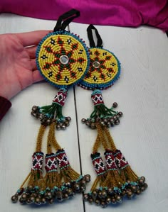 a person is holding some beaded items