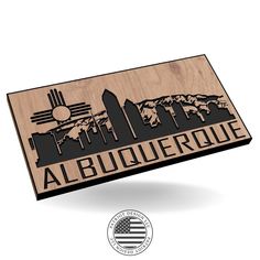 a wooden plaque with the word, albuquerque in black and white