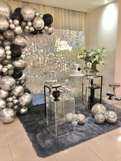 a table with silver balloons and vases on it