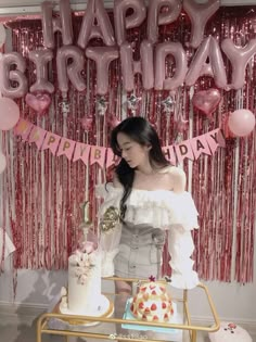 a woman standing in front of a birthday cake