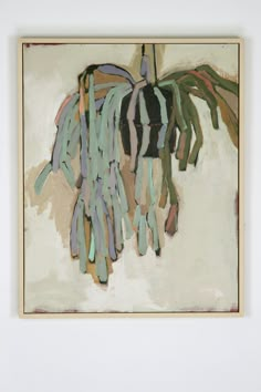 a painting hanging on the wall in front of a white wall with blue and green paint