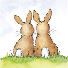 two brown rabbits sitting next to each other on top of a grass covered field with blue sky in the background