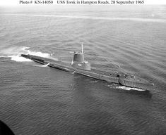 an old photo of a submarine in the water with another boat behind it, taken from above