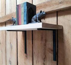 two metal mice are sitting on the shelf