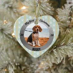 a christmas ornament with a photo of a dog on it hanging from a tree