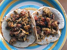 two tortillas on a plate topped with meat and veggie toppings