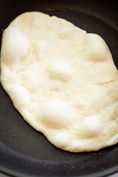 an uncooked piece of bread in a skillet