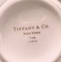 a white porcelain plate with the words tiffany & co new york and japan on it