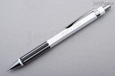 a silver pen sitting on top of a table