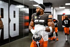 the cleveland browns players are walking through the locker room