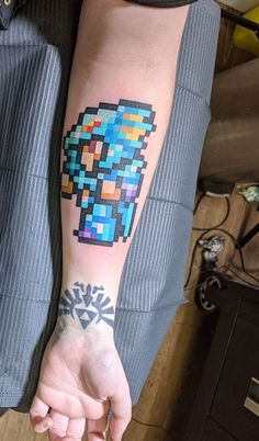 a person with a pixel tattoo on their arm