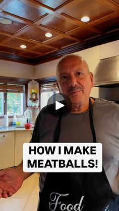 a man standing in a kitchen with an apron over his shoulder that says how i make meatballs