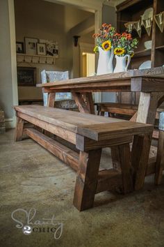 a wooden table and bench in a room