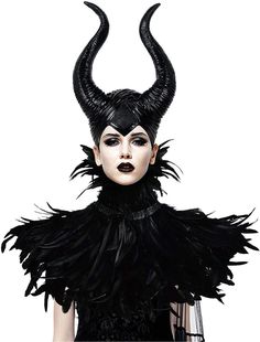 a woman with black makeup and horns on her head