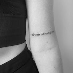 a woman with a tattoo on her arm that says to live for the hope of life