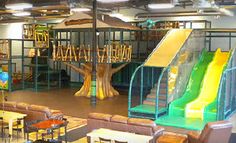 an indoor play area with slides and chairs