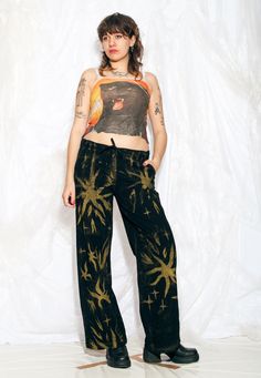 Y2K vintage trousers - these wide-leg, hand-painted flares are here to remind you that the early 2000s were an absolute fashion rollercoaster! We used industrial-quality textile paint which is machine washable. Features: - four pockets - zip closure - 100% cotton - reworked Every item we manage is cleaned and, when necessary, repaired, ensuring it arrives to you in top condition. Our model, Szedi is 170 cm / 66.3" tall and she's a size L. Size: L / US 8 / UK 12 / IT 44 Measurements:  waist (seam Vintage Bottoms For Summer Alternative Fashion, Festival Flare Cotton Pants, Grunge Straight Leg Bottoms For Festival, Cotton Flare Pants For Festivals, Artistic Hand Painted Bottoms For Summer, Vintage Black Bottoms For Festival, Vintage Black Festival Bottoms, Artistic Hand Painted Straight Leg Bottoms, Funky Pants Outfits