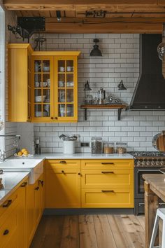 a kitchen with yellow cabinets and white tile backsplash, wood flooring and wooden floors