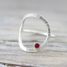 { P r o d u c t } An unusual ring that is forged and textured and set with a ruby. { M a t e r i a l s } - sterling silver ring - 18K gold bezel setting - ruby { D i m e n s i o n s } - 14 gauge wire - 3mm stone { S i z e s } I can make this ring in sizes 3 to 16 (US), including half and quarter sizes; if you are not able to select it from the drop down menu, please leave me a note at checkout with your size(s). {S h i p p i n g } - Canada: We offer free shipping on all orders over CAD $40. - US Forged Ring, Ring With Ruby, Silversmithing Jewelry, Modern Silver Jewelry, Handmade Silver Jewellery, Metalsmithing Jewelry, Unusual Rings, Metal Clay Jewelry, Etsy Gold Ring