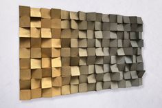 a wall sculpture made out of wooden blocks