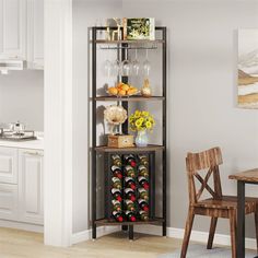 a wine rack in the corner of a kitchen with bottles and glasses on it, next to a dining room table