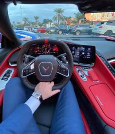 a man driving a red and black car