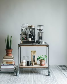 a coffee machine sitting on top of a metal cart