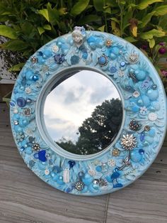 a blue mirror sitting on top of a wooden table