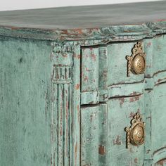 an old green painted dresser with brass handles and knobs on it's doors