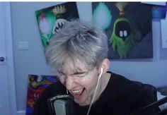 a woman with grey hair and headphones on talking on a cell phone in her living room