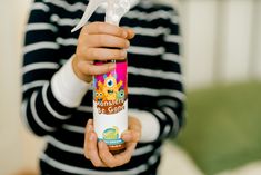 a child holding a spray bottle with an animal on it