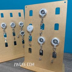 two display boards with different types of buttons and chains attached to the sides of them