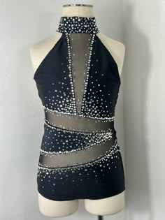 a mannequin wearing a halter top with silver sequins on it