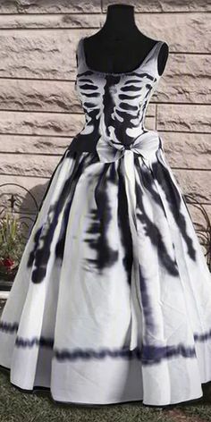 a dress that is on display in front of a wall