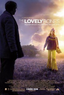 the lovely bones movie poster with a woman in yellow pants and a man standing next to her