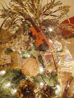 a christmas tree with ornaments and a violin on it