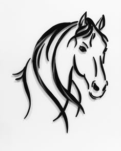 a black and white photo of a horse's head with long manes on it