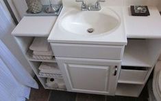 a white sink sitting next to a toilet in a bathroom