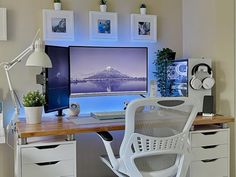 an office desk with a computer monitor, keyboard and chair in front of the window