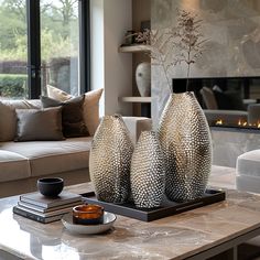 two vases sitting on top of a coffee table