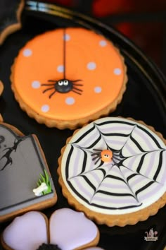 halloween decorated cookies on a black tray