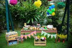 an outdoor birthday party with balloons and decorations