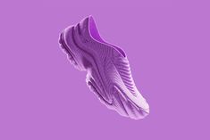 a pair of purple sneakers flying through the air on top of a purple background with space for text