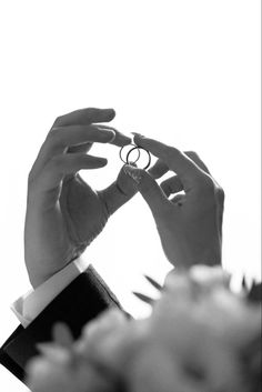 black and white photograph of a person holding a ring