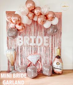 there is a pink and gold bridal backdrop with balloons on the wall behind it